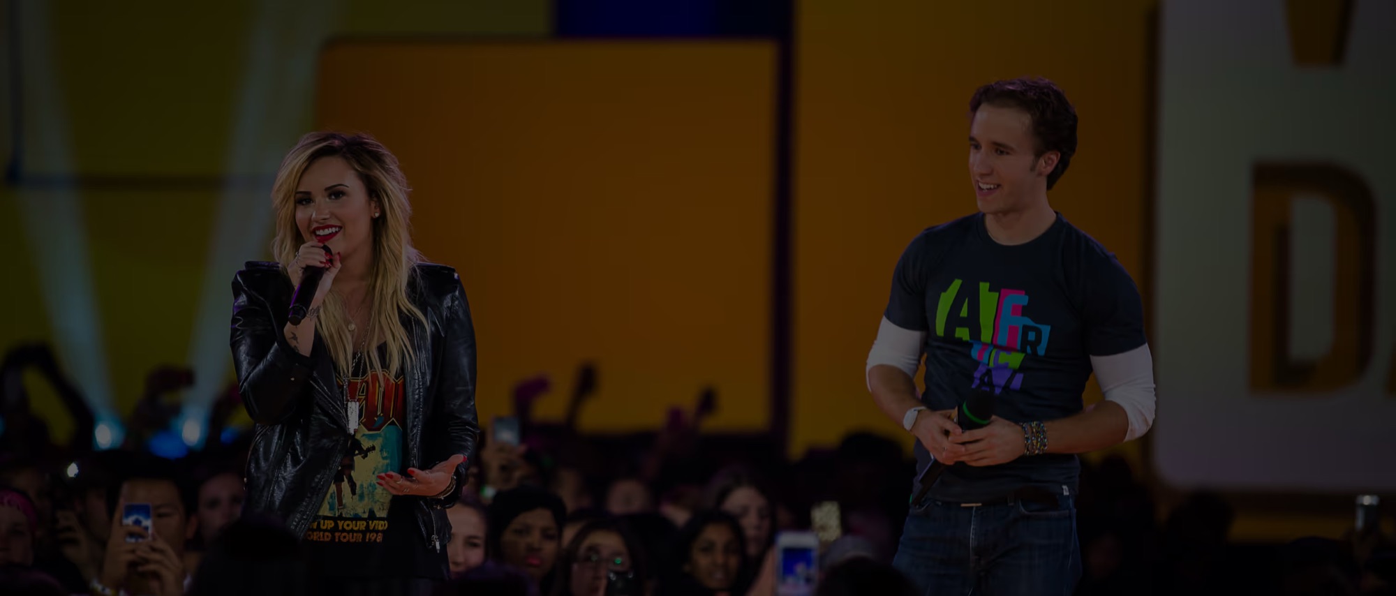Craig Kielburger speaking on stage at a live impact event