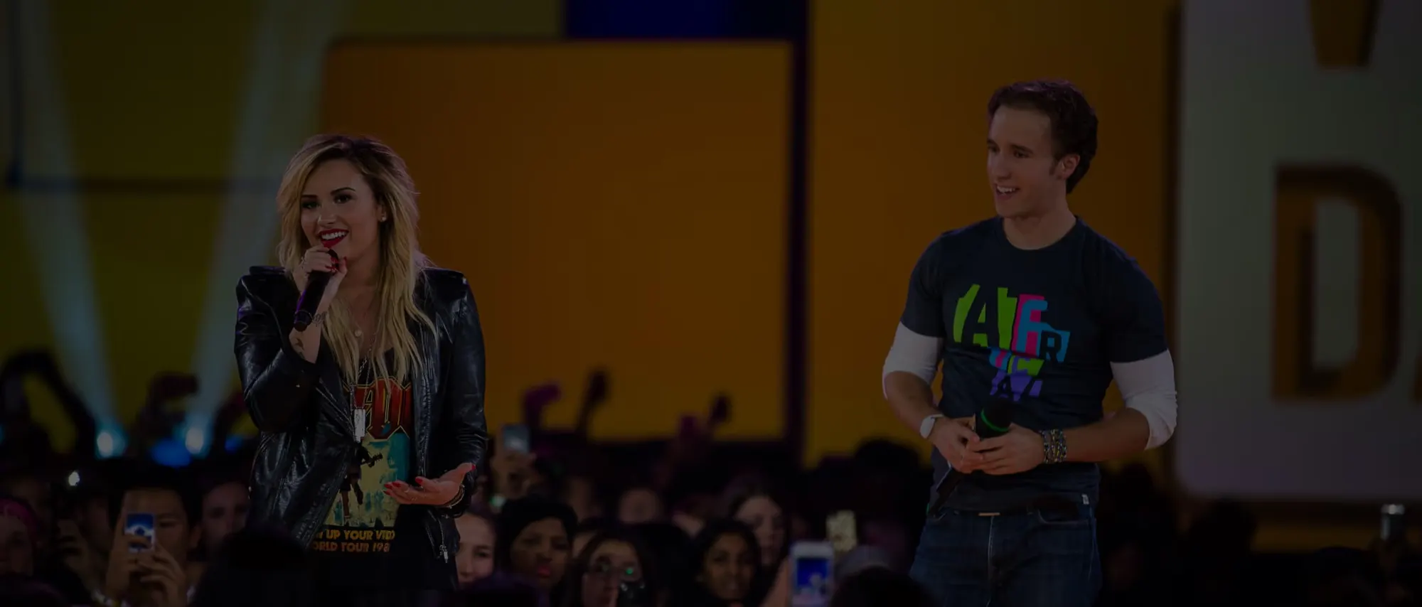 Craig Kielburger speaking on stage at a live impact event